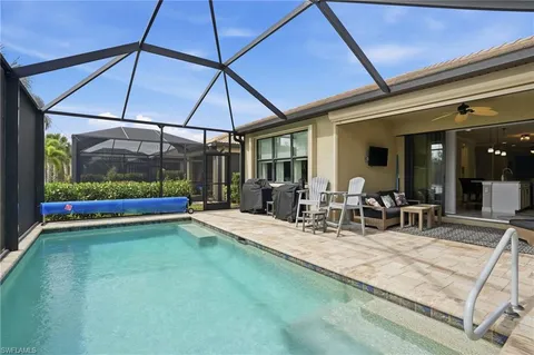 a view of a patio with a table and chairs under an umbrella