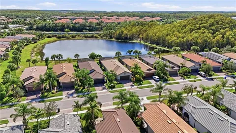 an aerial view of residential houses with outdoor space and river