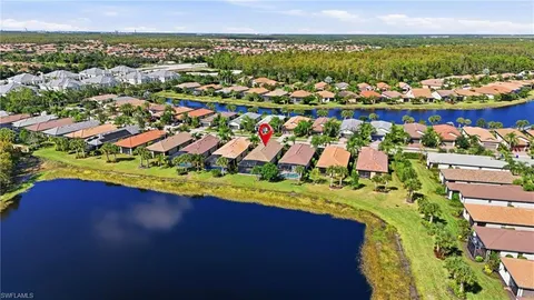 an aerial view of residential houses with outdoor space and swimming pool