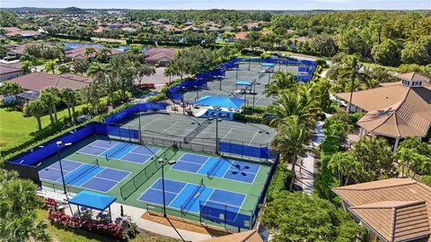 an aerial view of a houses with yard and swimming pool