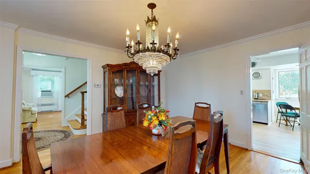 a view of a dining room with furniture and chandelier