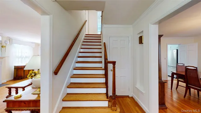 a view of entryway with wooden floor and stairs