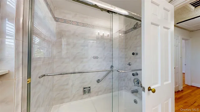a bathroom with a glass shower door