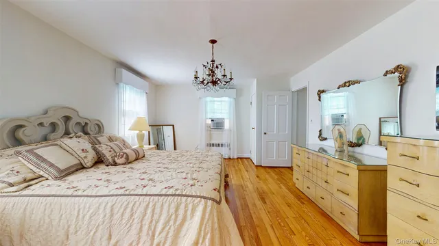 a spacious bedroom with a bed and a dresser