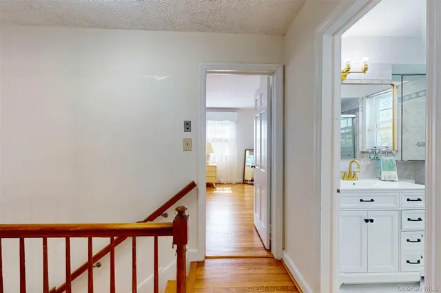 a view of a hallway with closet and mirror