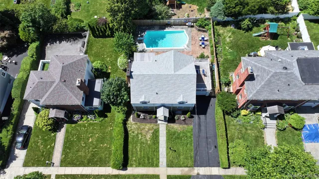 an aerial view of multiple houses with yard