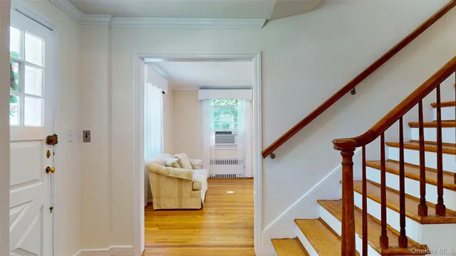 a view of a hallway with wooden floor and staircase