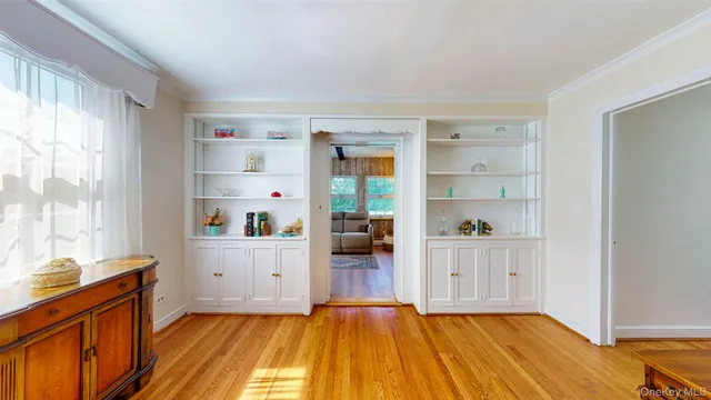 a hallway with cabinet and wooden floor