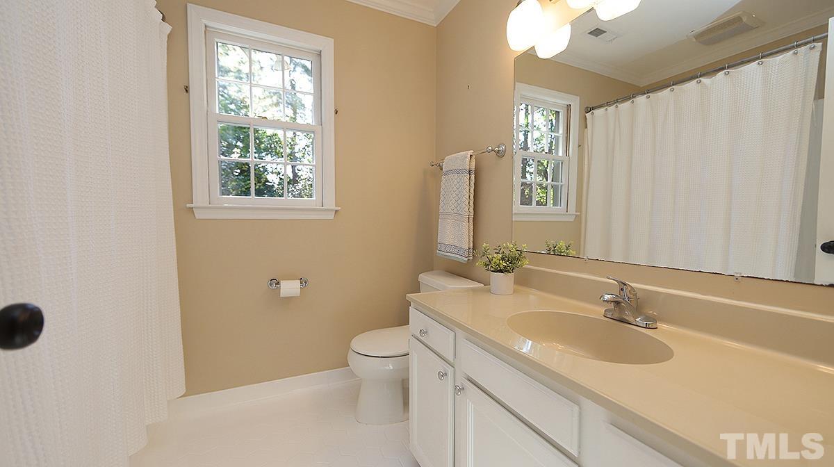 1104 Sapling Place Raleigh, NC 27615 - Photo 13 of 19 a bathroom with a granite countertop sink a toilet and a mirror