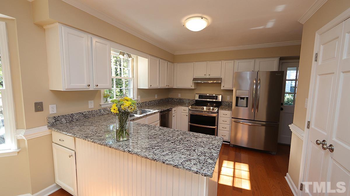 1104 Sapling Place Raleigh, NC 27615 - Photo 3 of 19 a kitchen with granite countertop a refrigerator oven a sink and dishwasher
