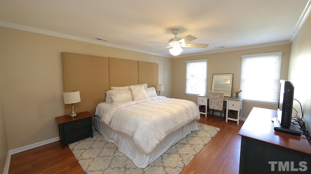 1104 Sapling Place Raleigh, NC 27615 - Photo 8 of 19 a spacious bedroom with a bed and a flat screen tv