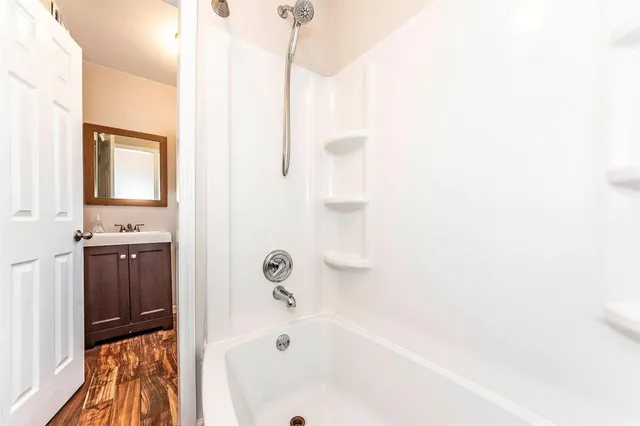 a bathroom with a bathtub and a shower