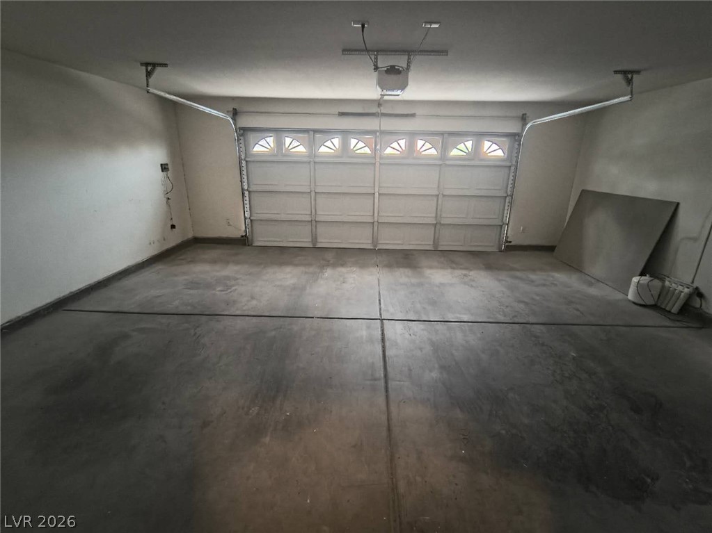 9725 Pima Point Avenue Las Vegas, NV 89147 - Photo 35 of 35 A spacious and pristine garage, ready to house vehicles or serve as a flexible utility area.
