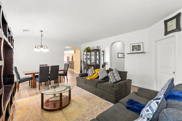 a living room with furniture and wooden floor