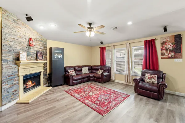 a living room with furniture and a fireplace