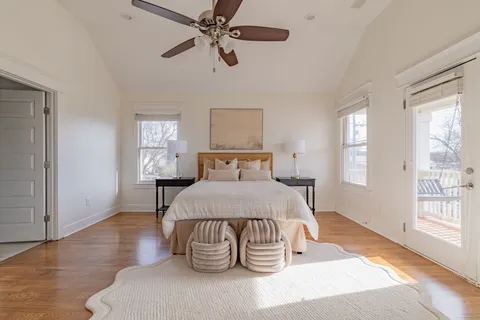 a bedroom with a bed and wooden floor