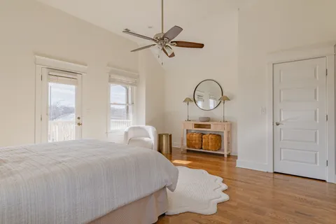 a bedroom with a bed a mirror and a window