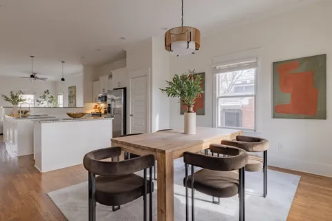 a view of a dining room with furniture and wooden floor