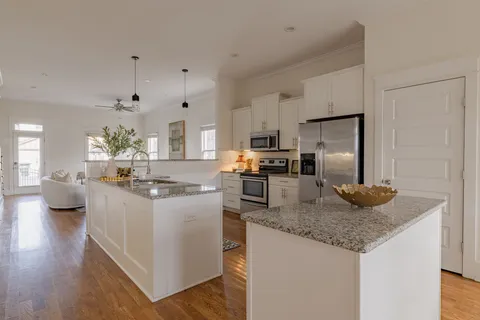 a kitchen with sink refrigerator and microwave
