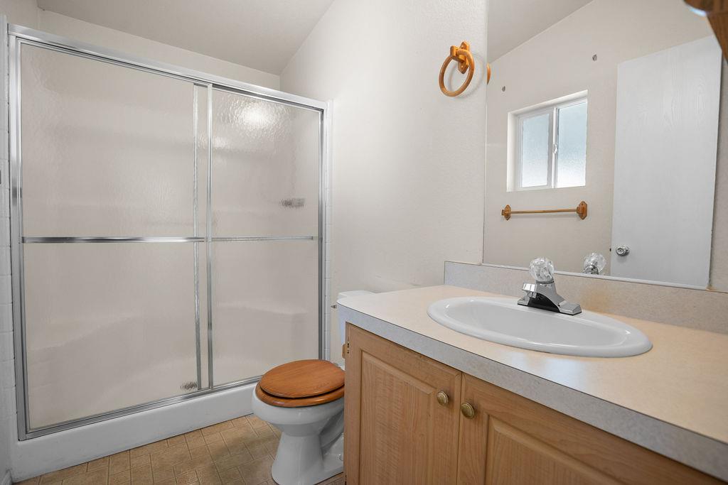 1281 Pleasant Valley Road, Unit 44 Diamond Springs, CA 95619 - Photo 19 of 27 a bathroom with a sink a toilet and shower