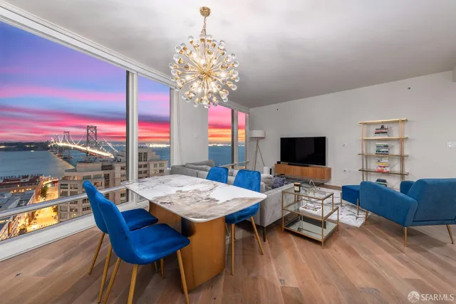 a living room with furniture a chandelier and a flat screen tv