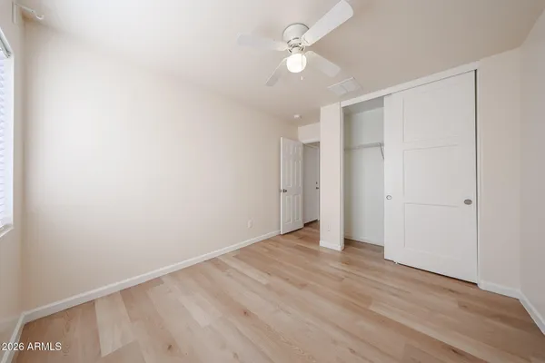 a view of an empty room with a fan