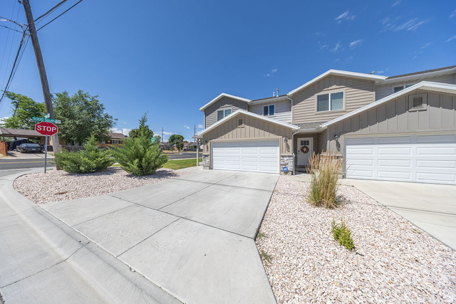 4991 South 475 West Washington Terrace, UT 84405 - Photo 5 of 31 Contemporary multi-level exterior. Attached garage. Concrete driveway. Low-maintenance landscaping featuring decorative rock and established shrubs.