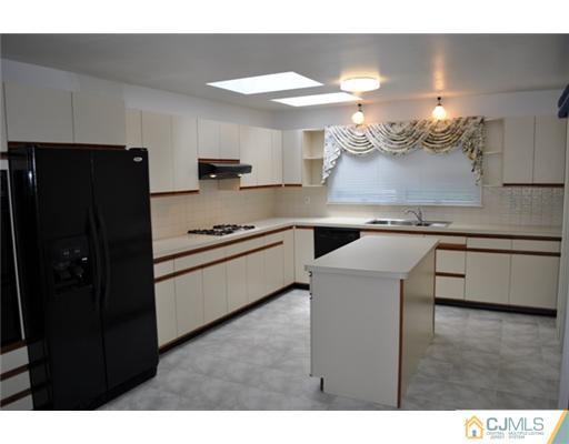 1 Agate Road East Brunswick, NJ 08816 - Photo 11 of 25 a kitchen with stainless steel appliances granite countertop a refrigerator a stove and a sink