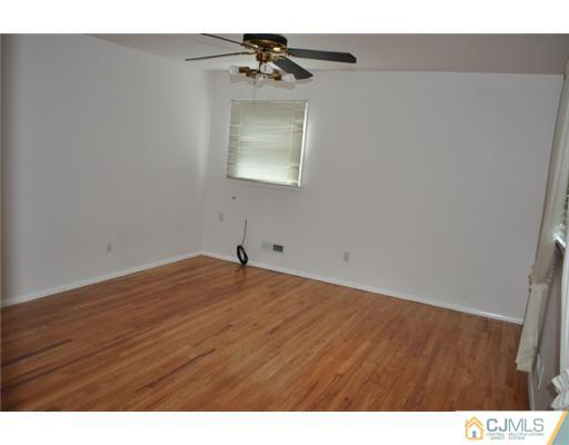 1 Agate Road East Brunswick, NJ 08816 - Photo 15 of 25 a view of empty room with wooden floor