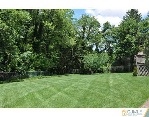 1 Agate Road East Brunswick, NJ 08816 - Photo 22 of 25 a view of a green field with trees in the background