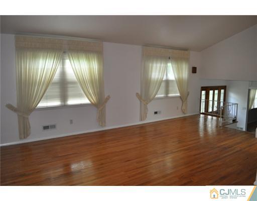 1 Agate Road East Brunswick, NJ 08816 - Photo 6 of 25 a view of an empty room with window and wooden floor
