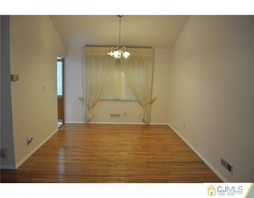 1 Agate Road East Brunswick, NJ 08816 - Photo 9 of 25 a view of empty room with wooden floor