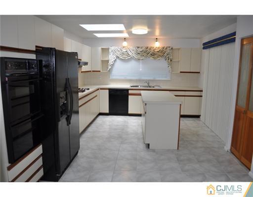 1 Agate Road East Brunswick, NJ 08816 - Photo 10 of 25 a kitchen with a refrigerator and a sink