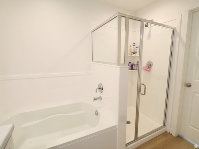 8240 Cascade Vw Way Magna, UT 84044 - Photo 7 of 18 Bathroom with a garden tub, a stall shower, vanity, and light wood-style flooring