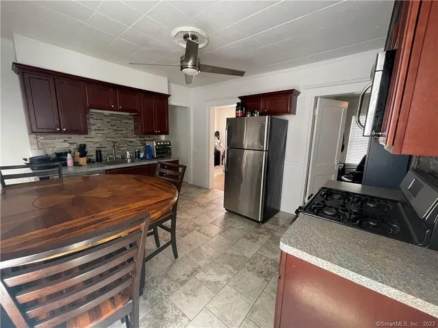 a kitchen with refrigerator and table