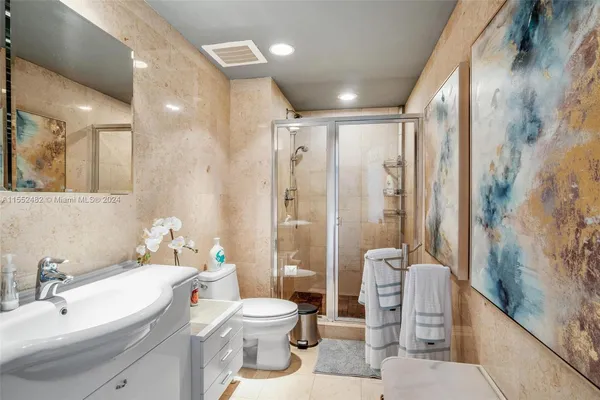 a bathroom with a sink toilet and shower