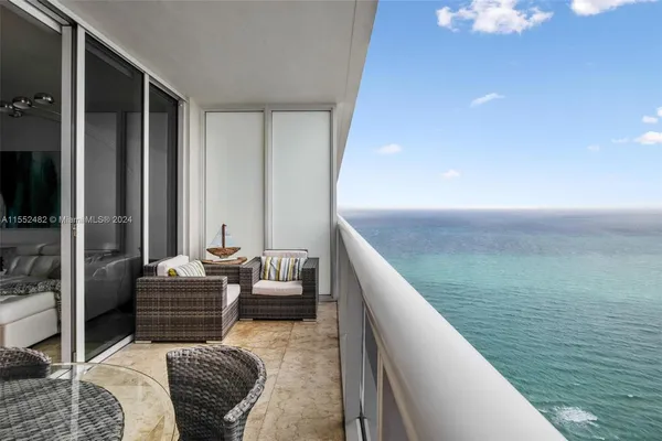 a balcony with furniture and a potted plant