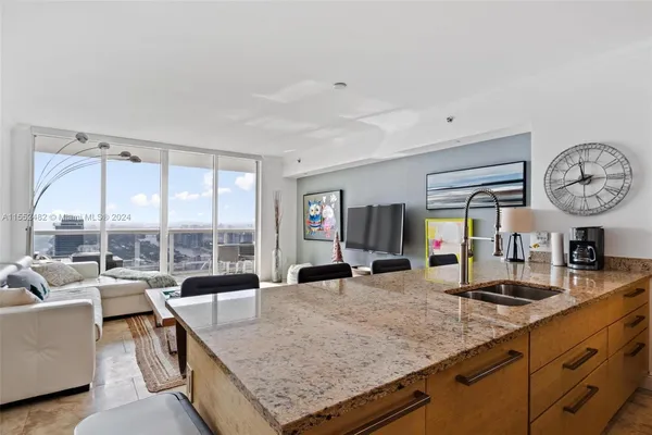 a very nice looking living room with a large window and a clock