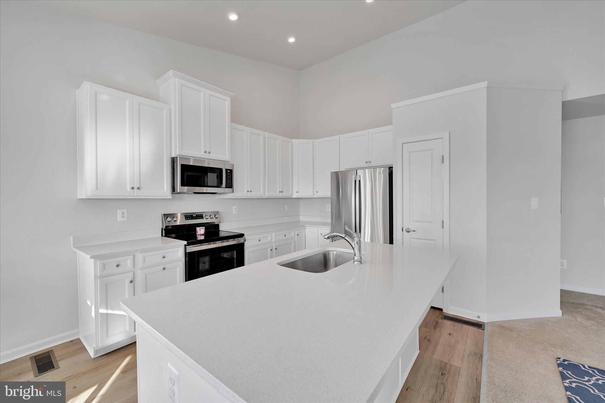 415 Courtland Road Atglen, PA 19310 - Photo 7 of 26 a kitchen with stainless steel appliances a refrigerator stove microwave and sink
