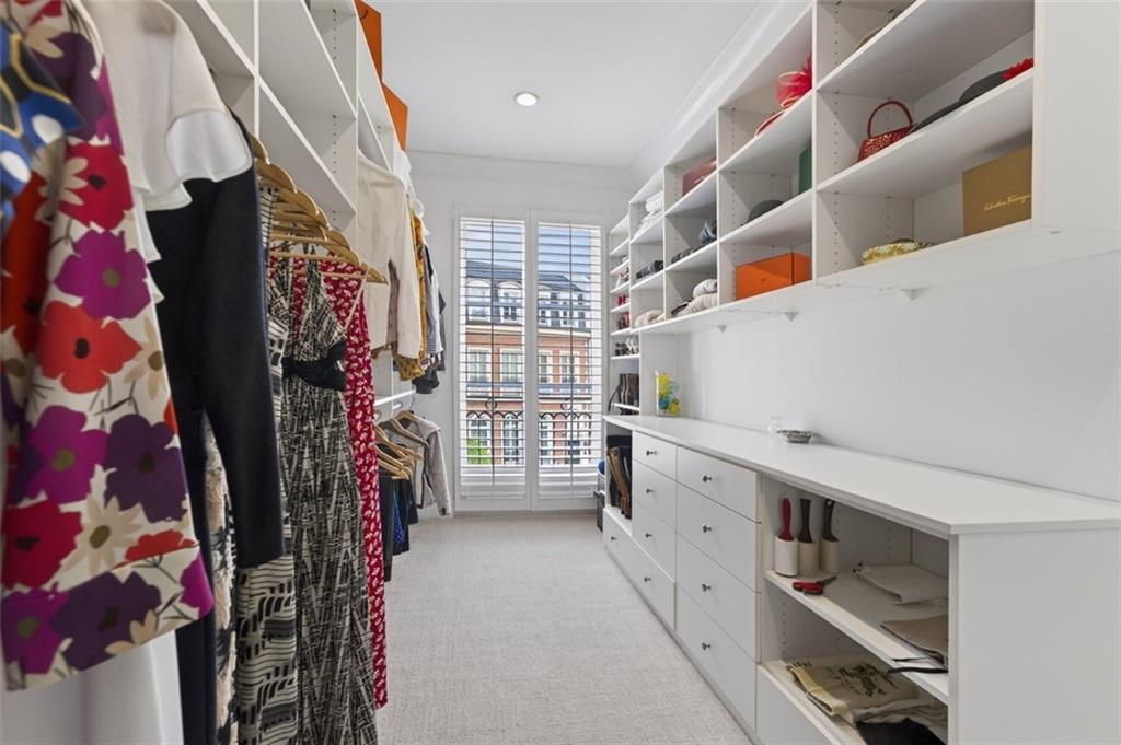 2288 Peachtree Road Northwest, Unit 4 Atlanta, GA 30309 - Photo 24 of 50 a view of walk in closet with clothes and shoes