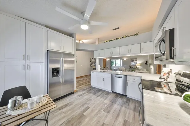 a kitchen with refrigerator cabinets and wooden floor