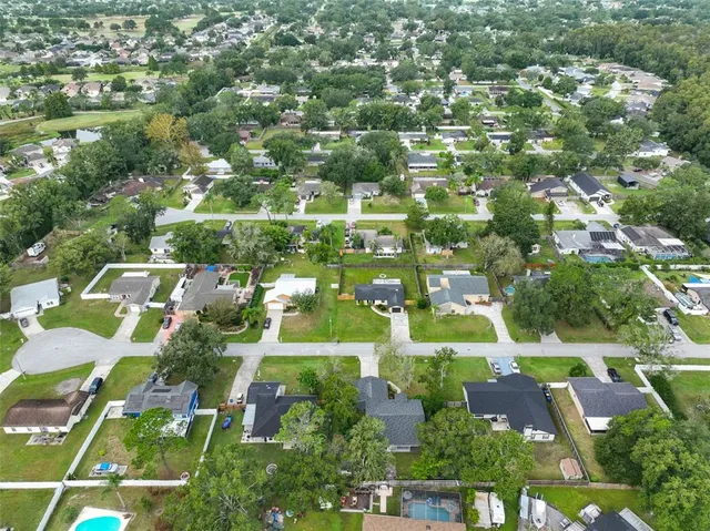 an aerial view of residential houses with outdoor space and street view