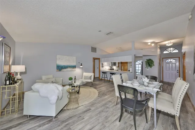 a view of a dining room with furniture and wooden floor