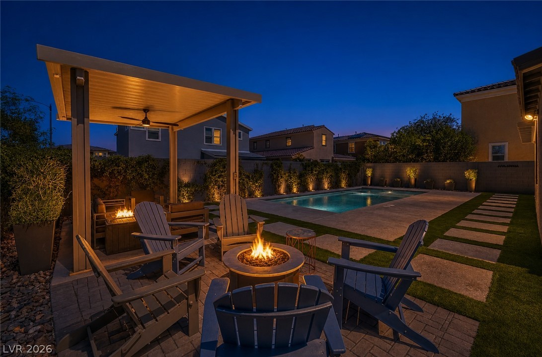 2166 Trivero Street Henderson, NV 89044 - Photo 52 of 61 An inviting backyard oasis offers a serene pool, covered patio, and a crackling fire pit.