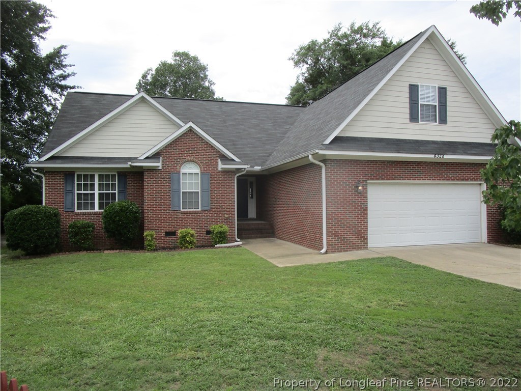 4328 Rocinta Court Hope Mills, NC 28348 - Photo 1 of 39 a front view of a house with a yard and garage