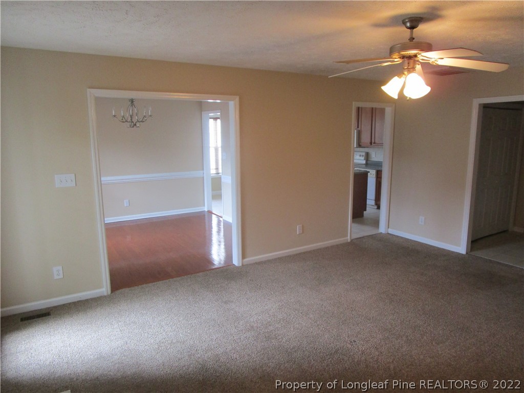 4328 Rocinta Court Hope Mills, NC 28348 - Photo 11 of 39 a view of an empty room with a chandelier fan