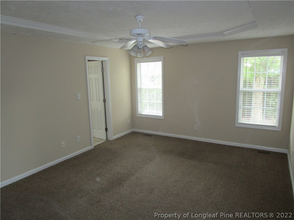 4328 Rocinta Court Hope Mills, NC 28348 - Photo 12 of 39 en empty room with windows and chandelier fan