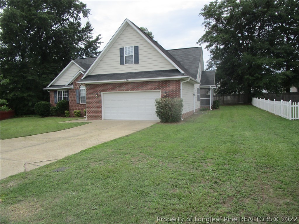 4328 Rocinta Court Hope Mills, NC 28348 - Photo 2 of 39 a front view of house with yard and trees