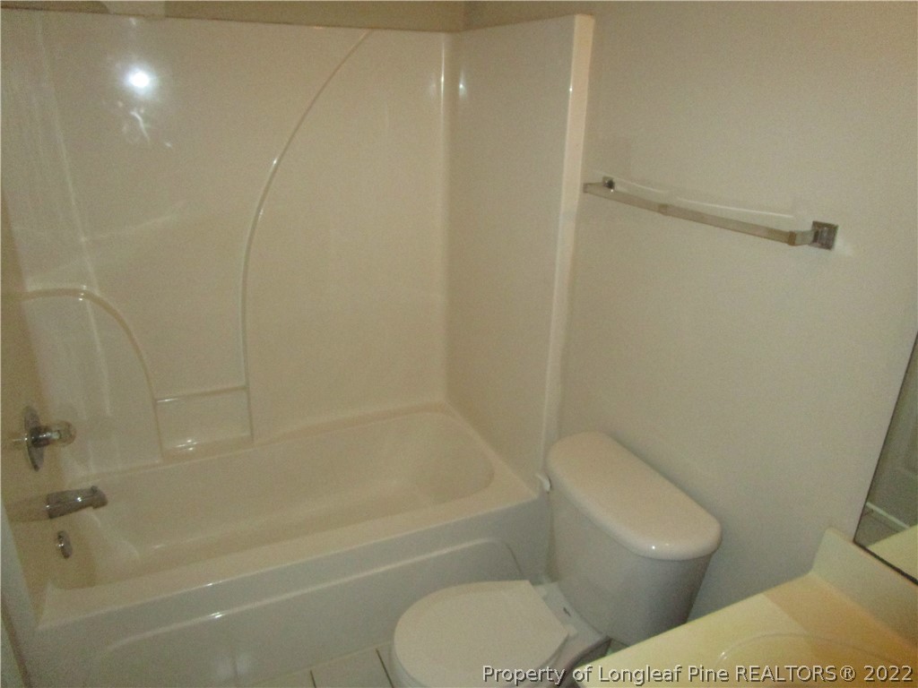 4328 Rocinta Court Hope Mills, NC 28348 - Photo 35 of 39 a white toilet and tub sitting next to a bathroom sink
