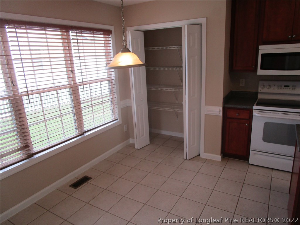 4328 Rocinta Court Hope Mills, NC 28348 - Photo 5 of 39 a kitchen with stainless steel appliances a sink a stove and a refrigerator